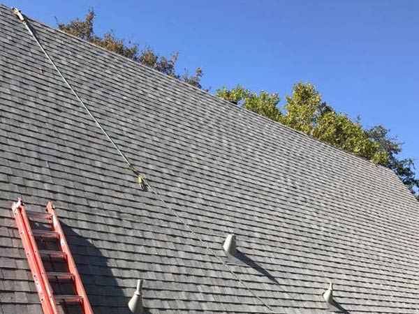 a roofer in Sonora is adding the final touches to the roof