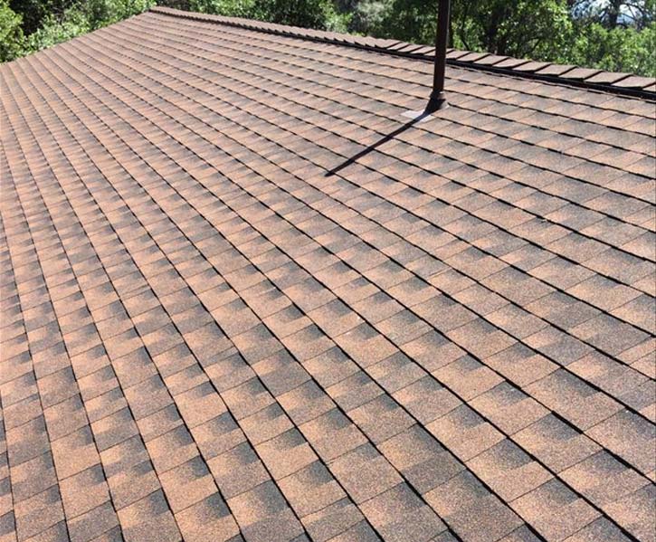 roof with red shingles repaired by our roofing contractors