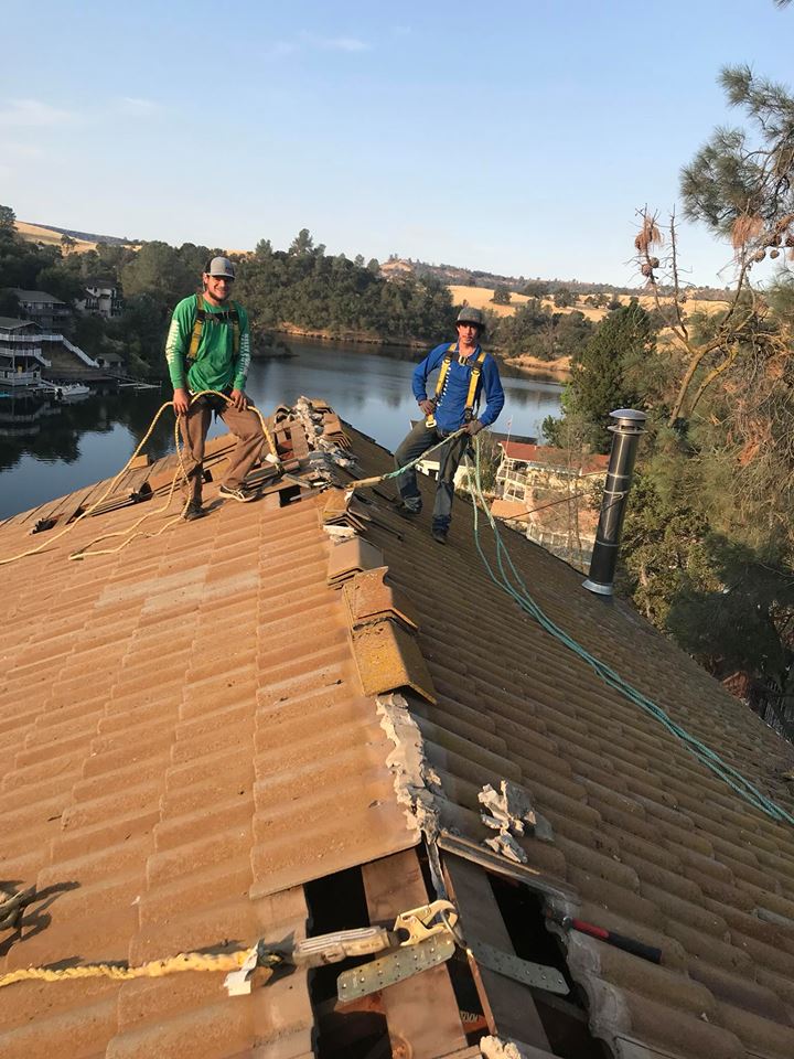two professional kelly roofing replacing shingles on a residential home in lodi ca