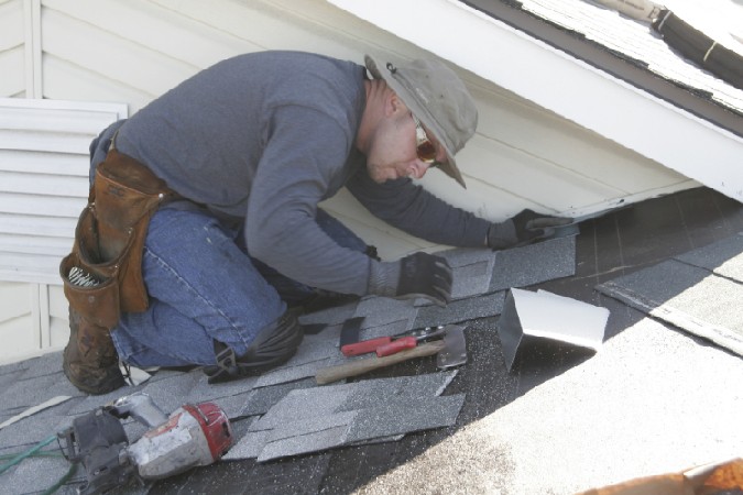 kelly roofing roofing contractor repairing a roof in groveland